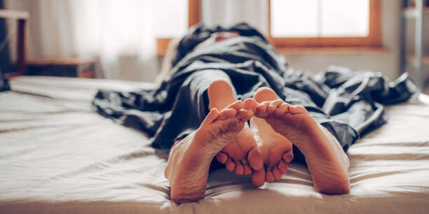 Adult couple’s feet looking out of bed Things women want in bed