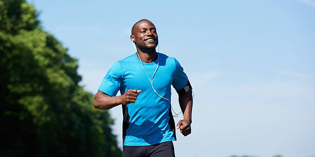 Portrait of an active african american man running exercise workout outdoors